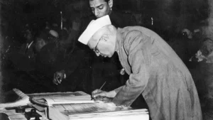 Jawaharlal Nehru signs the Constitution at the final session of the Constituent Assembly on January 24, 1950. | Photo Credit: The Hindu Archives
